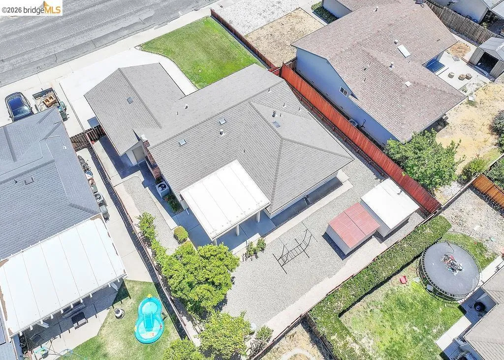 Single-story residence featuring a gray shingle roof and an attached garage
