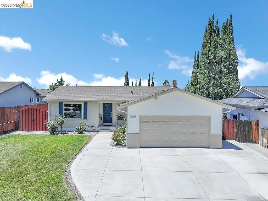 Single-story property featuring a front-facing attached two-car garage, concrete driveway, and a manicured lawn