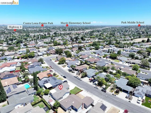 Aerial overview of a residential neighborhood with tree-lined streets