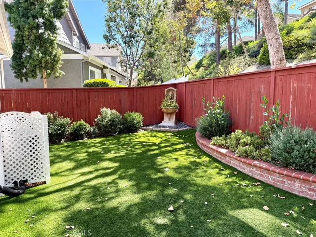 Private side yard with concrete patio