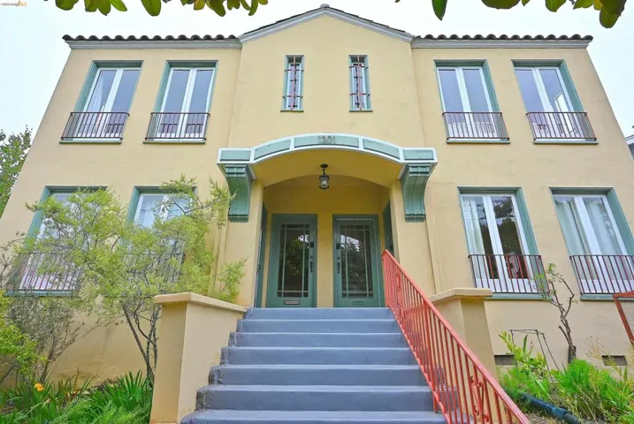 Stucco exterior with a terra cotta tile roofline