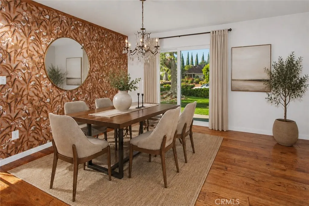 Photo is virtually staged.  Property shows as in previous photo. The dining room, filled with natural light from new vinyl sliding glass doors, provides an inviting setting for casual family dinners and holiday celebrations alike.
