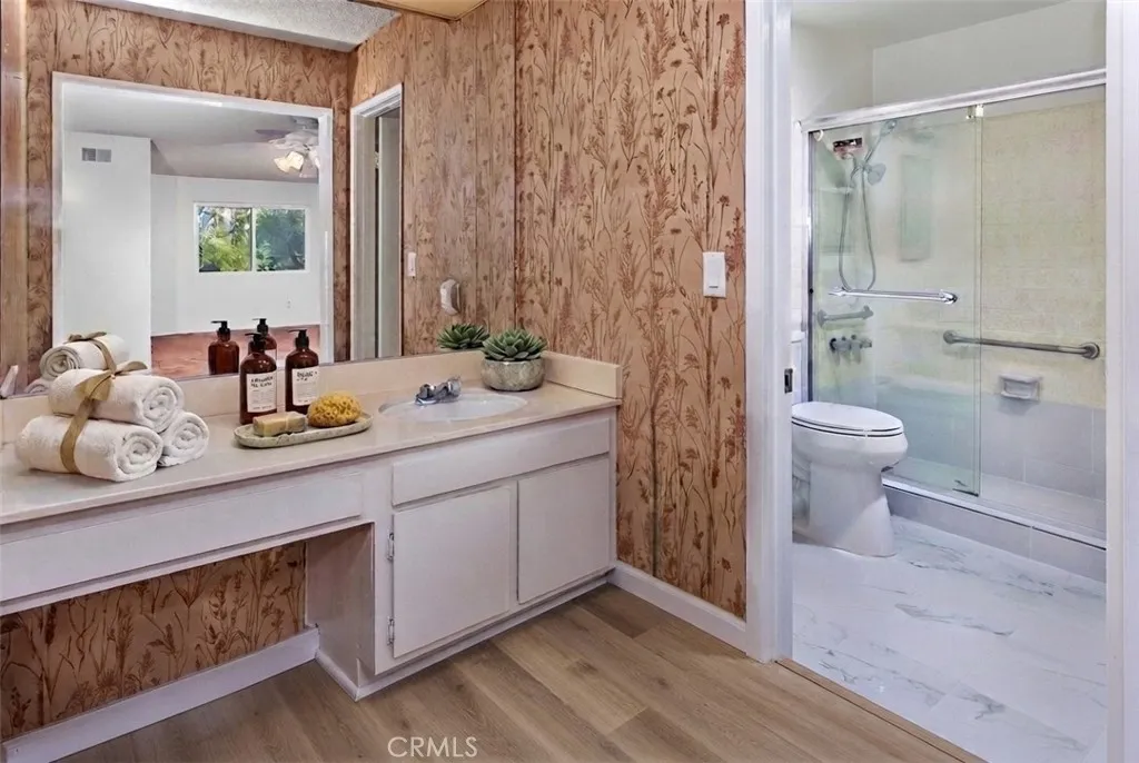 Photo is virtually staged.  Property shows as in previous photo. The remodeled primary bath provides both comfort and functionality.