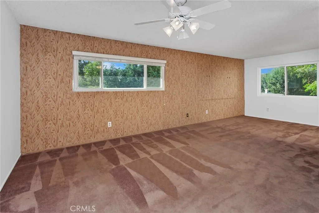 Upstairs, the generous primary suite offers a peaceful retreat where new vinyl windows frame unobstructed views of the treetops, surrounding hillsides, and West Hills neighborhoods.