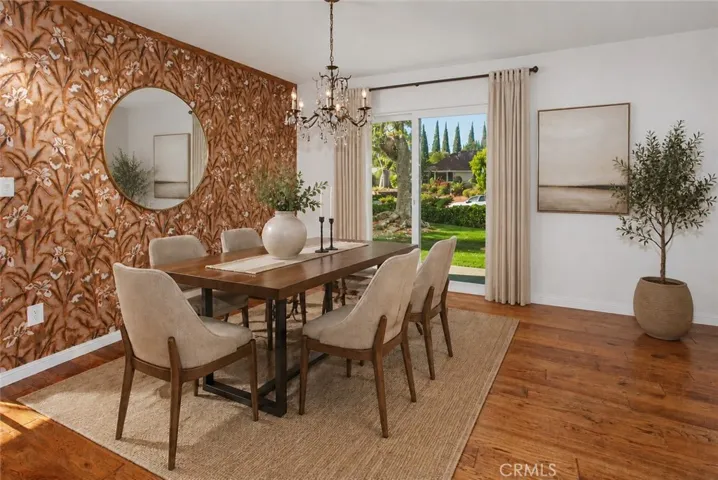 Photo is virtually staged.  Property shows as in previous photo. The dining room, filled with natural light from new vinyl sliding glass doors, provides an inviting setting for casual family dinners and holiday celebrations alike.
