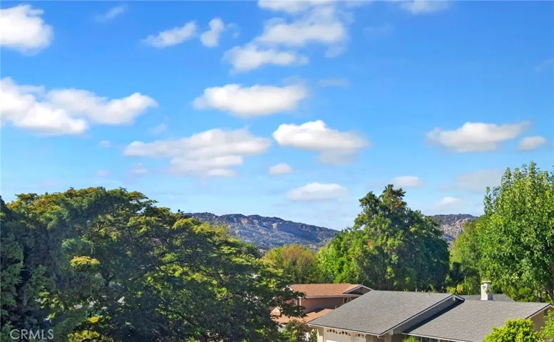 Upstairs, the generous primary suite offers a peaceful retreat where new vinyl windows frame unobstructed views of the treetops, surrounding hillsides, and West Hills neighborhoods.