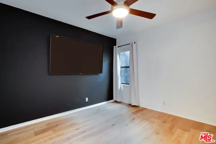 back bedroom with 75" TV