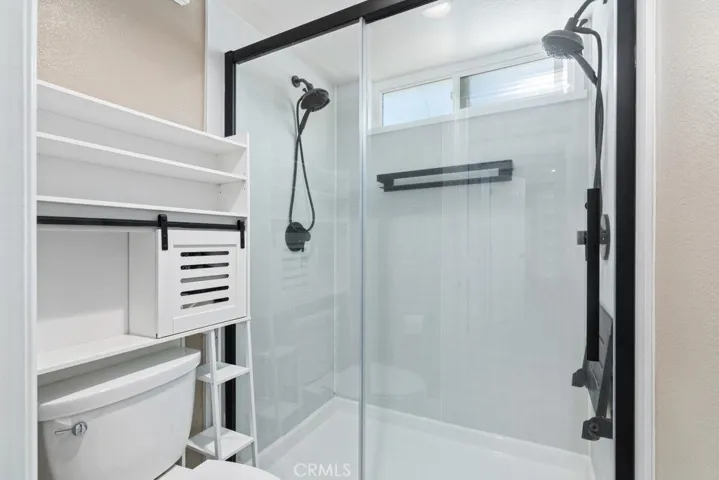 primary shower and toilet with privacy door