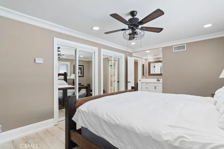 primary bedroom with 2 mirrored wardrobe closets