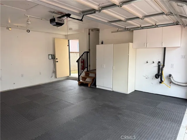 The garage has two access doors. One to the backyard, and the the one with the steps,  leading to the bedroom.