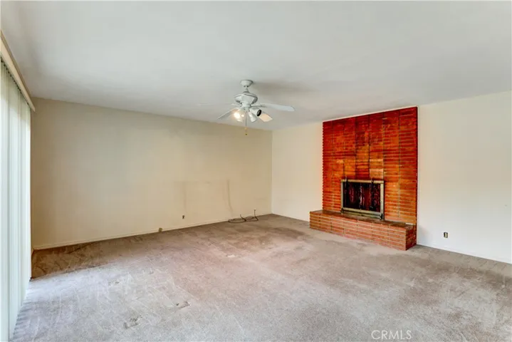 The big family bedroom has three access doors. 1) to the side yard. 2) sliding door to the backyard. 3) to the hallwaay leading to a full bathroom, laundry room, and the kitchen