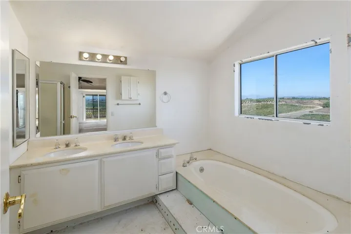 Primary bath with double sinks, soaking tub, walk-in shower not shown, no toilet.
