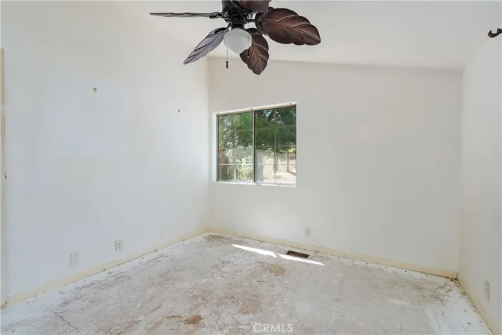Bedroom 3 needs flooring and paint. It has a Ceiling fan & mirrored closet doors.