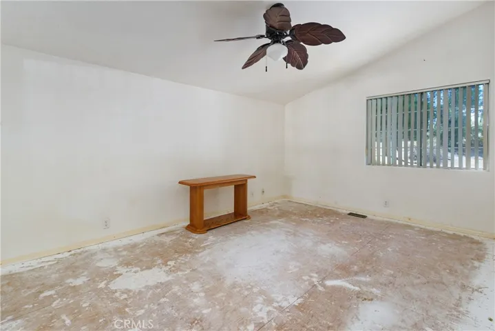 Bedroom 2-needs flooring and paint. It has a Ceiling fan and mirrored closet doors.
