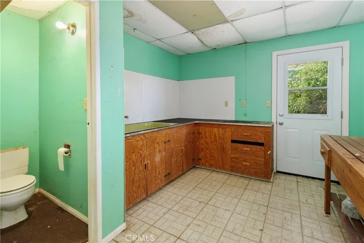 Additional room in the garage for a gardening or potting area and Pet grooming with  deep tub, a separate toilet,cabinetry, and gardening bench. Not known if permitted.