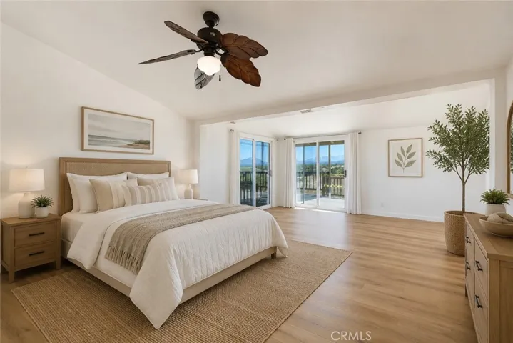 Primary bedroom virtually staged with flooring.