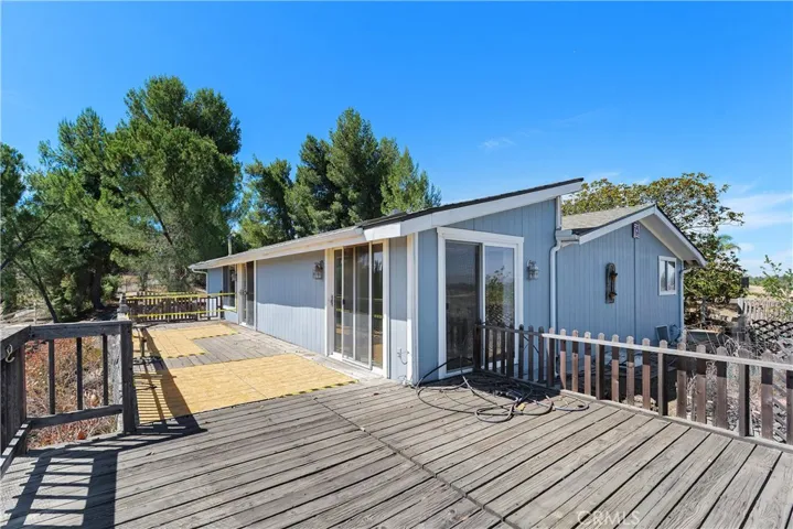 Large wooden deck needs repairs but offers an additional outdoor living space with views!