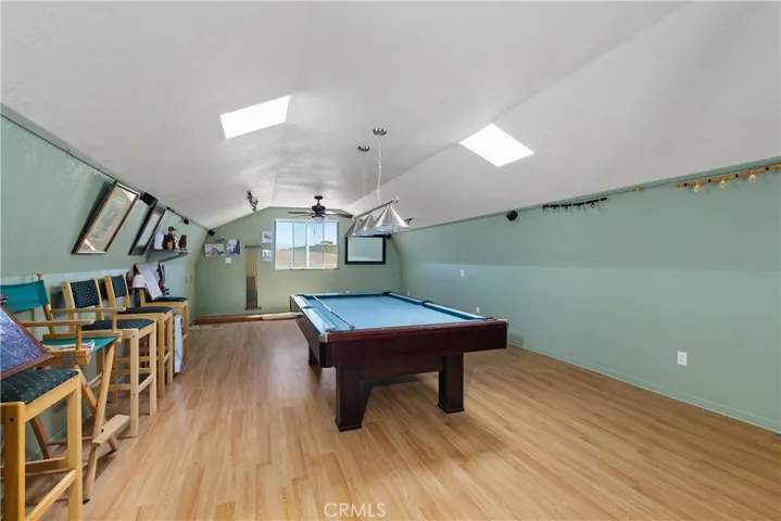 Fully finished loft above barn/workshop with laminate flooring, 2 skylights, a sliding door to the trex deck entry from outside. The pool table, equiptment and chairs are included. ADU potential. Buyers to do thier own investigation regarding this with Riverside County.