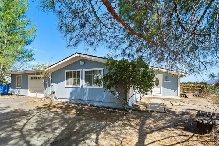 Single story home with attached garage with an additional room. Parking area not shown is ample!