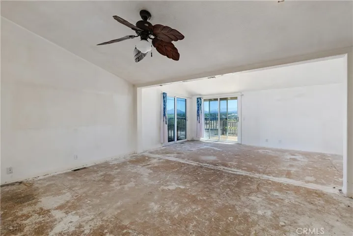 View of Primary bedroom with the retreat and 2 sets of sliding doors to the deck with panoramic views.
