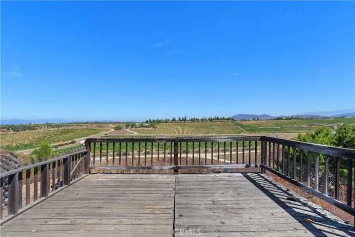 The deck off the front of the home and off the primary bedroom faces the South Coust Winery. See the South Coast cabanas, vineyards and all jsut off Anza Rd.