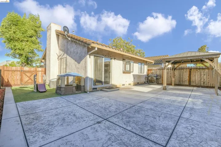 Expansive stamped concrete patio with an adjacent gazebo