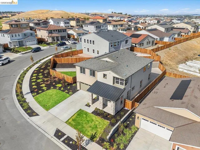 Contemporary two-story residence featuring a stone veneer facade and a modern metal roof accent over the entry