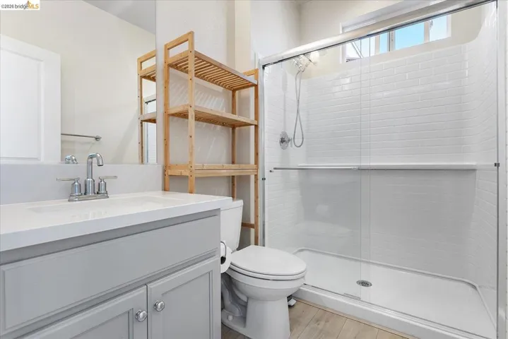 Bathroom featuring a light gray vanity with a white countertop and integrated sink, chrome faucet, and a large mirror