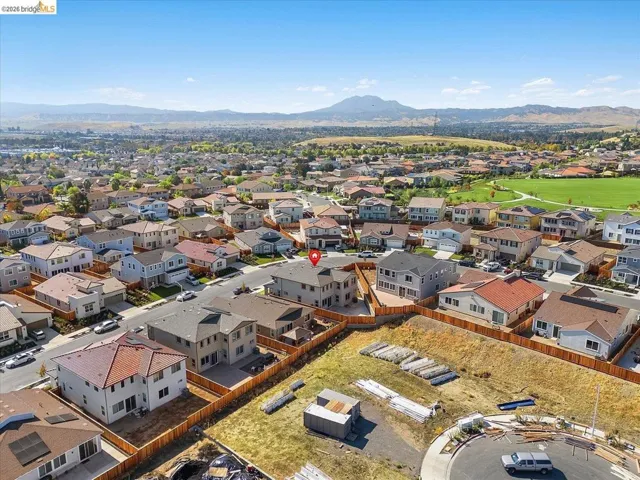 Aerial perspective showcasing a residential neighborhood with distant mountain ranges
