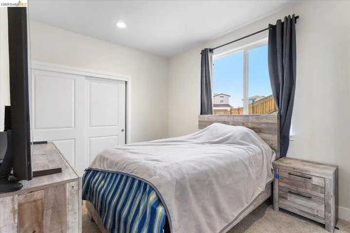 Bedroom featuring light-colored walls and carpet flooring