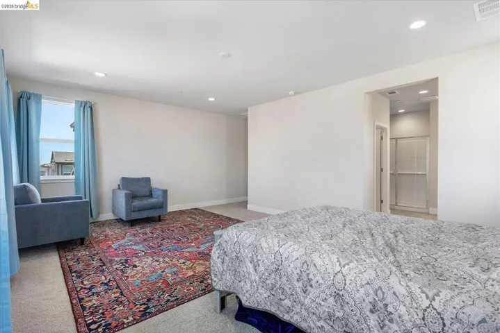 Spacious room with light-toned walls and recessed lighting