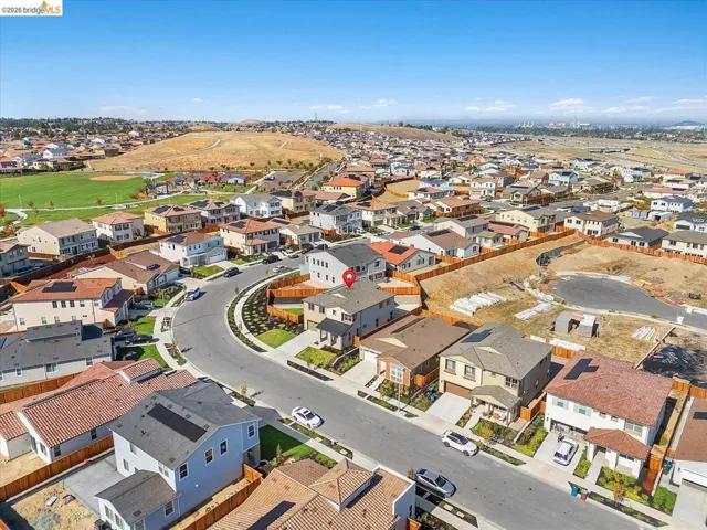Aerial perspective highlighting a suburban residential area with a curved street layout