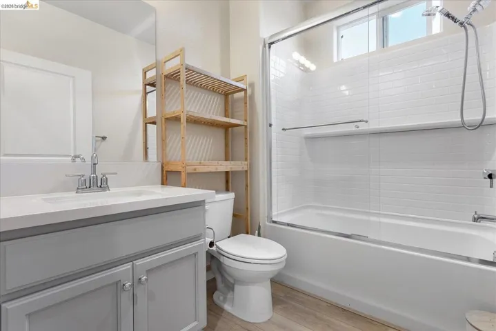Bathroom featuring a light gray vanity with a white countertop and rectangular sink
