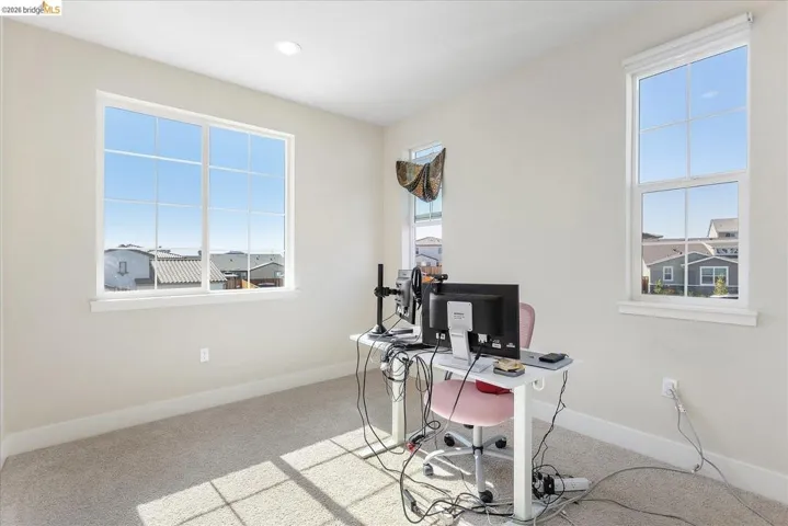 Room featuring light-colored carpet, white baseboards, and neutral wall paint
