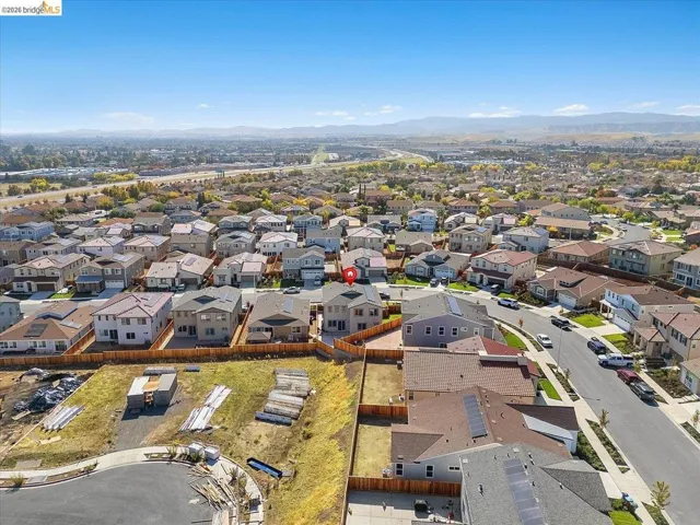 Aerial perspective of a developed residential area with distant mountains