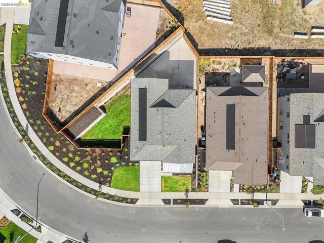 Aerial view showcasing a residential property with a partial green lawn