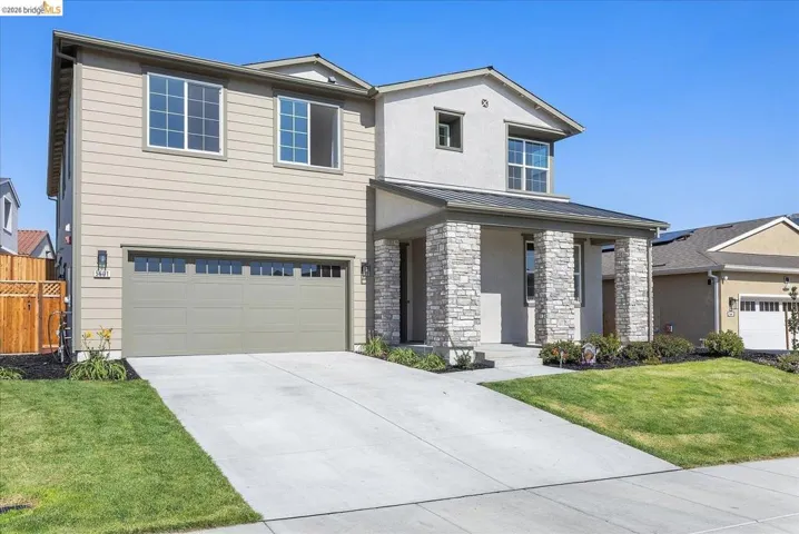 Two-story residence featuring a stone veneer and stucco facade