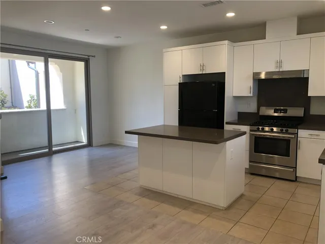 Kitchen, dining area, and balcony.
