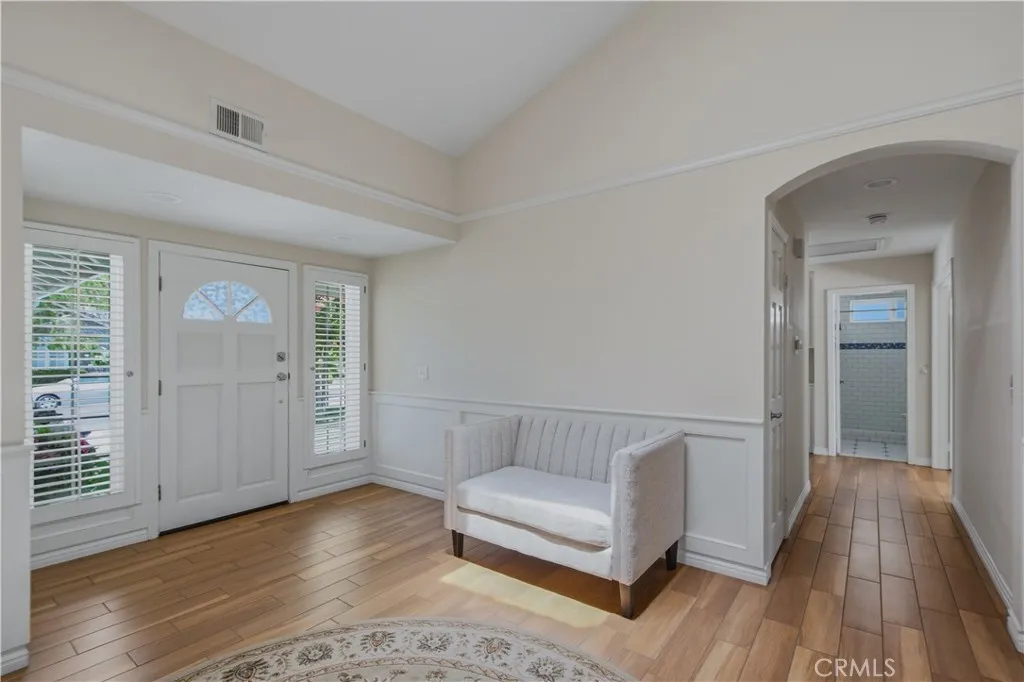 Another view of main entrance living room and hallway leading to bathroom and bedrooms.