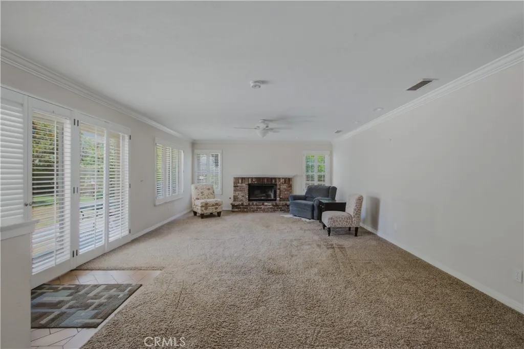 Direct view into family room from dining room area included, family room fireplace, dual pane windows and sliders leading into back yard, recessed lighting and fane with light.