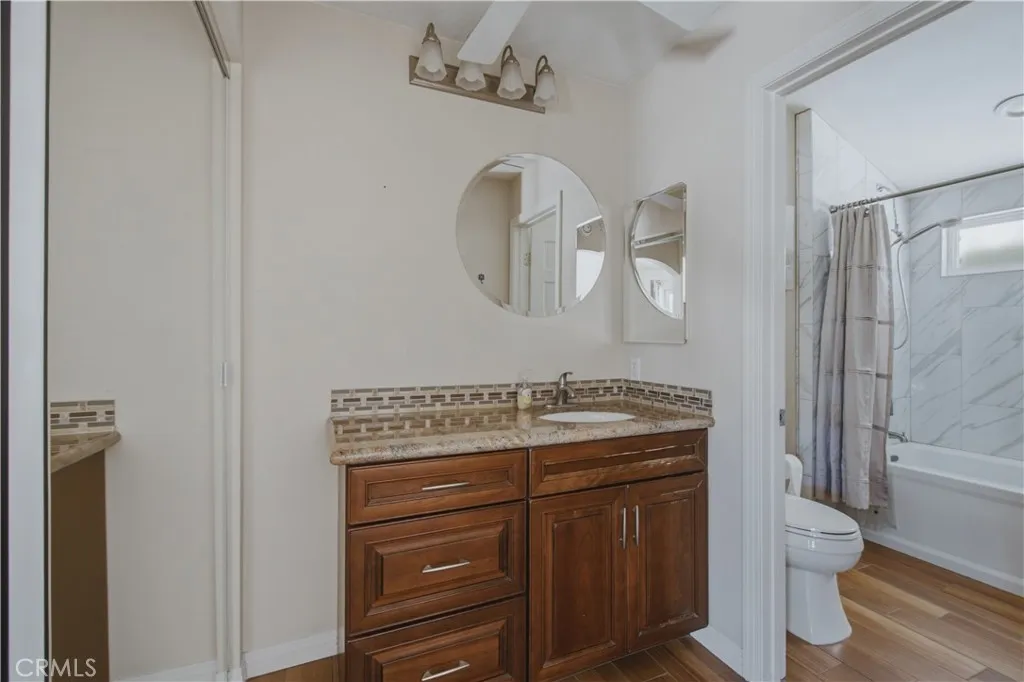 Primary ensuite bathroom including pocket door for toilet and shower privacy.