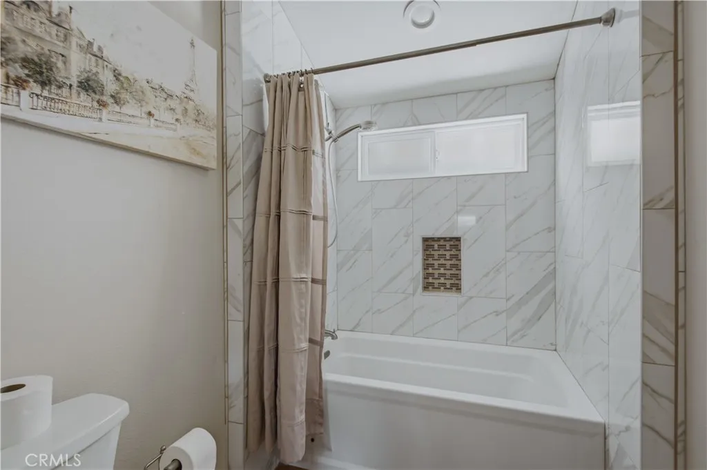 Primary ensuite bathroom including tub and shower in tub.