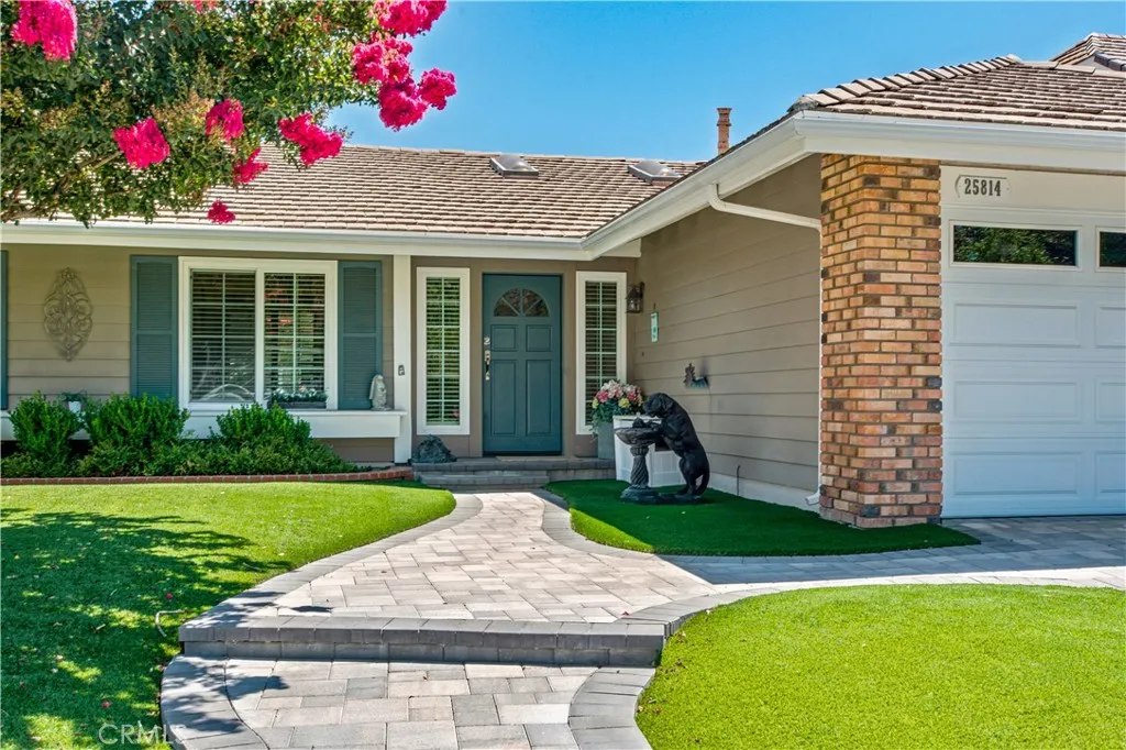 Front entry and interlocking concrete paver walkway.