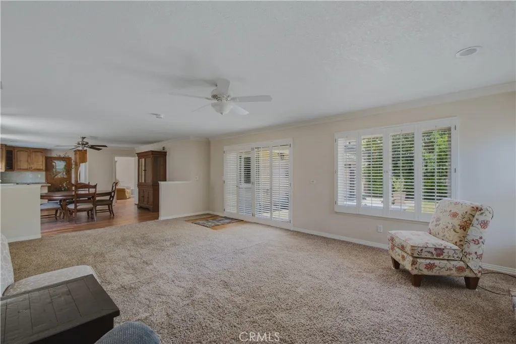 Family room leading into dining room area, including dual pane windows and sliders leading into back yard.