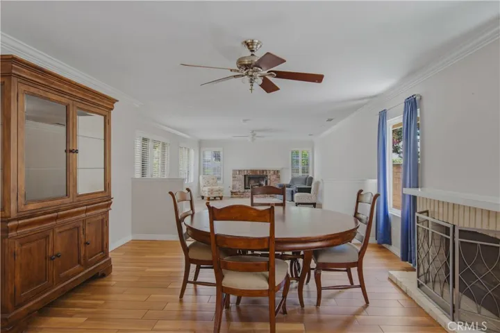 Dining and kitchen view from family room, including dining room area fireplace.