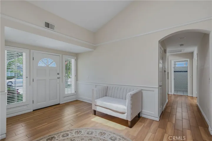 Another view of main entrance living room and hallway leading to bathroom and bedrooms.