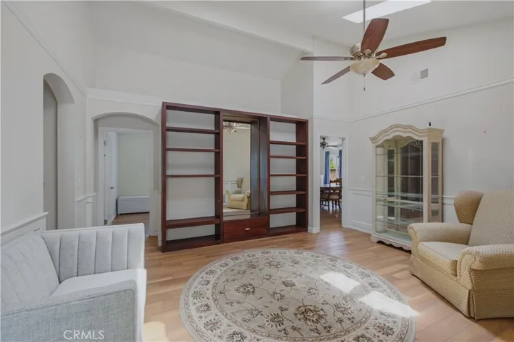 Another view of main entrance living room including built in entertainment center.