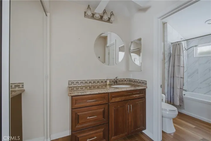 Primary ensuite bathroom including pocket door for toilet and shower privacy.