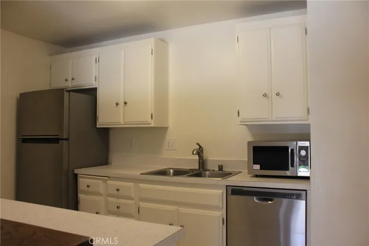 Kitchen with refrigerator, dishwasher & microwave