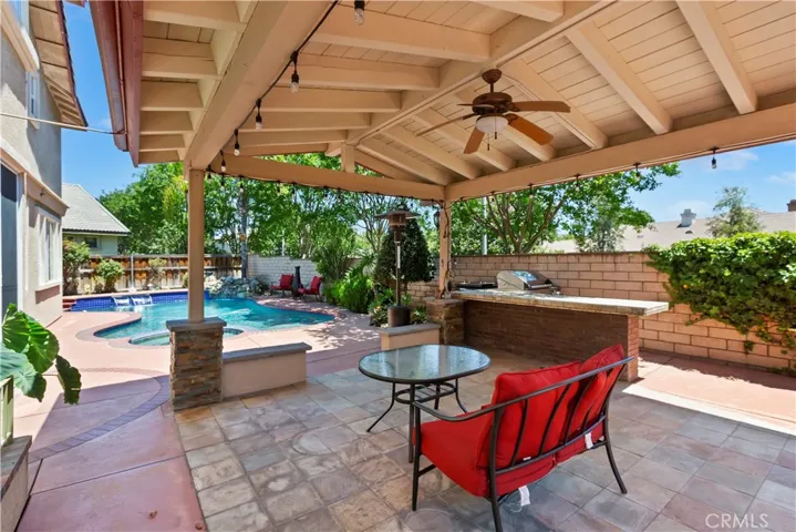 A wonderful covered patio with fan and  island.
